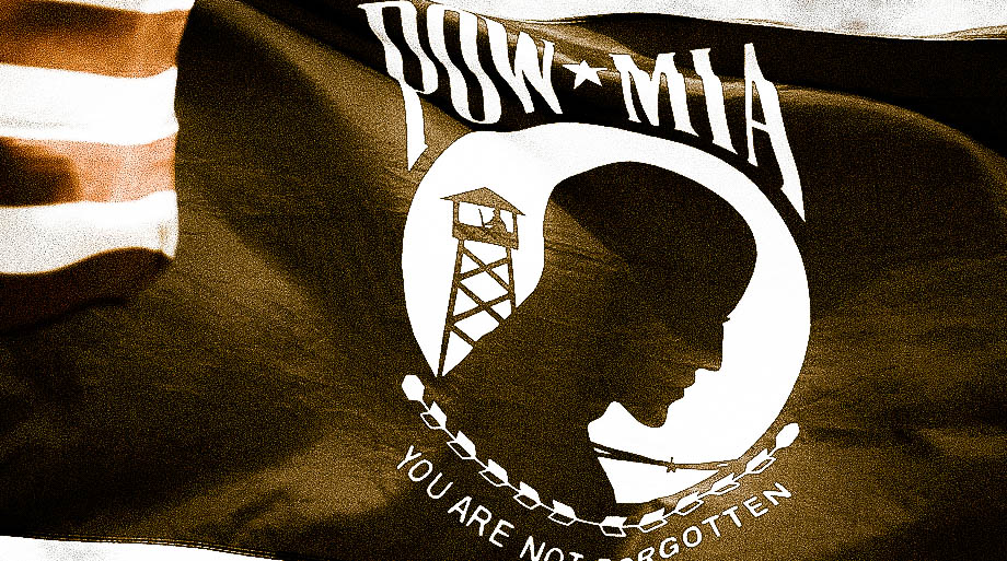 POW MIA Flag with American Flag touching flying high and proud.