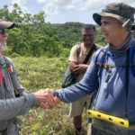 Glenn Frano receives his BentProp Coin on his first mission in the jungles of Palau by Team Leader Pat Scannon during Palau WWII POW search