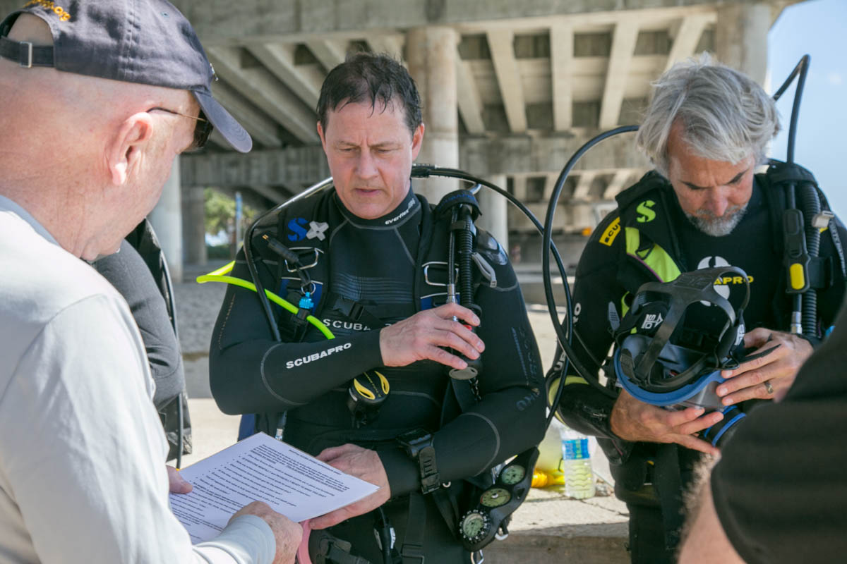 Dan O'Brien giving mandatory safety checklist to divers using technology for search recover of MIA- Photo By Harry Parker Photography