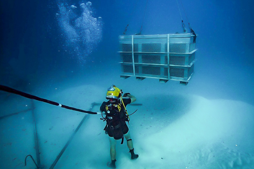 Navy Diver working underwater ocean MIA recovery Palau basket of remains